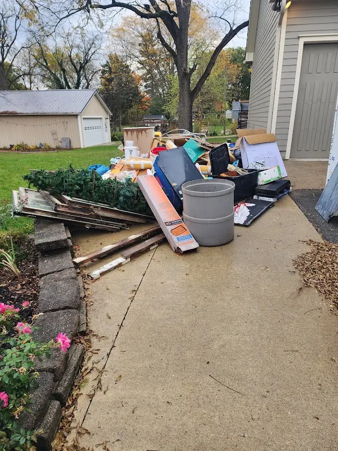 Dumpster being loaded with debris for 12 Yard Dumpster Rental in Fairbury